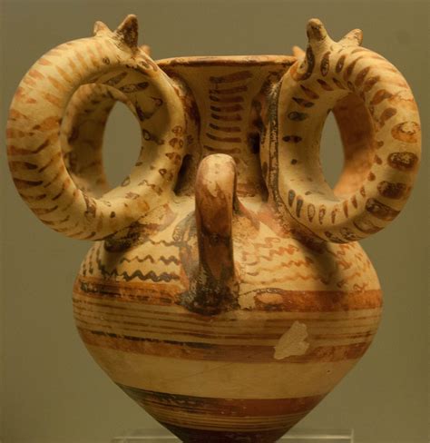 An Old Vase With Two Horns On It
