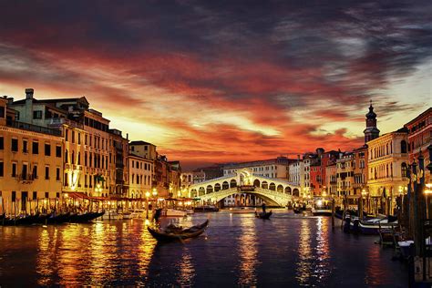 Ponte Rialto And Gondola On Water Reflecting Sunset Colors