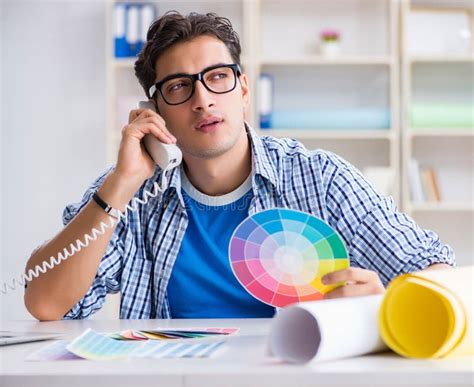 Young Designer Working On New Project And Choosing Colours Stock Image