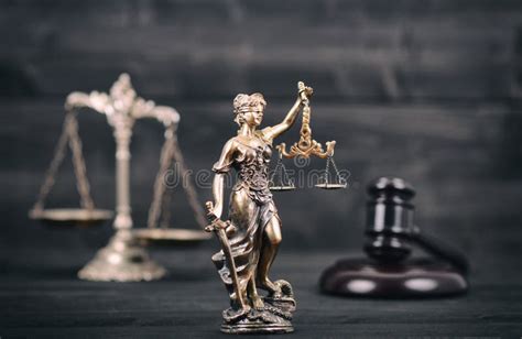 Lady Justice Scales Of Justice And Judge Gavel On A Black Wood Stock