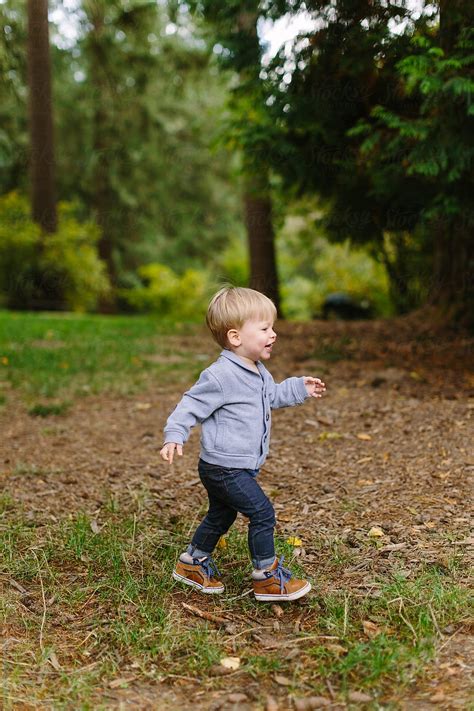 Young Boy Walking In Park By Stocksy Contributor Leah Flores Stocksy