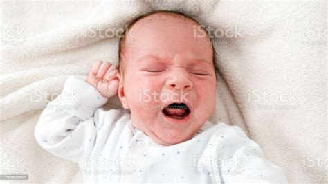 Top View Closeup Shot Of Newborn Baby Boy Crying Beacuse Of Feeling