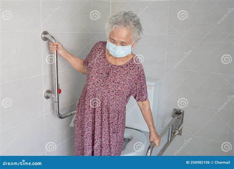 Asian Senior Or Elderly Old Lady Woman Patient Use Toilet Bathroom Handle Security In Nursing