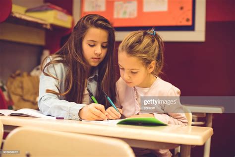 School Children Helping Each Other High Res Stock Photo