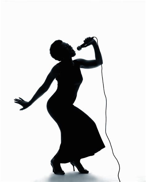 Silhouette Of Female Singer Singing On Microphone Photograph by PM Images