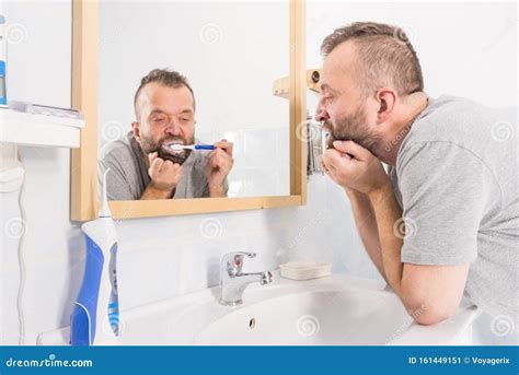 Bored Guy Brushing His Teeth In Bathroom Stock Image Image Of