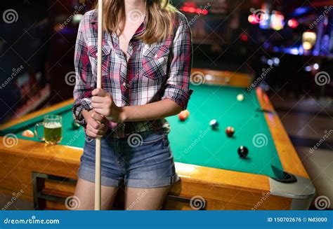 Young Beautiful Woman Having Fun And Playing Billiard In A Club Stock