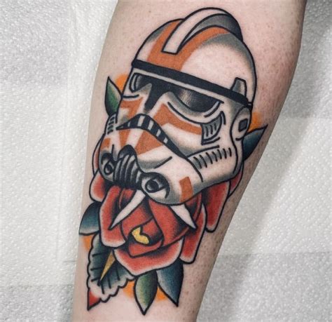 a star wars tattoo on the leg of a person with a rose in front of it