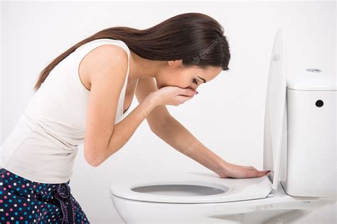Premium Photo Young Woman Vomiting Into The Toilet Bowl