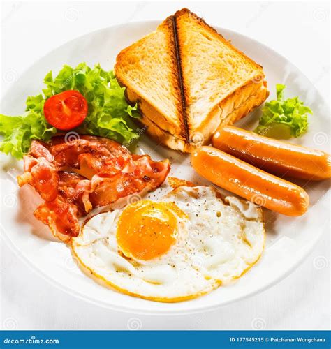 Western Breakfast Consisting Of Ham Fried Egg Sausage And Toast Stock