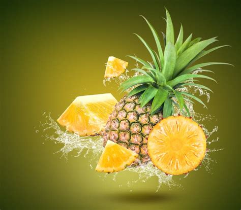 Water Splash On Fresh Pineapple With Leaves Isolated On Green