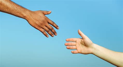 Black hand man helping white person - Different skin color hands - South Peninsula Hospital