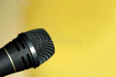 Microphone On Bright Yellow Background With Place For Text Stock Image