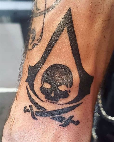 A Man S Arm With A Skull And Crossbone Tattoo On It