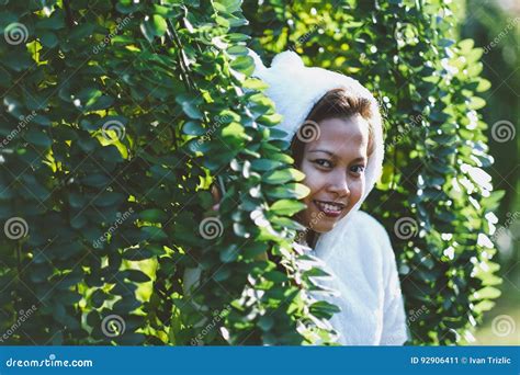 Beautiful Girl Wearing White Jacket Hiding Behind The Bush Stock Image Image Of Attractive