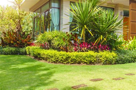 Front Yard Landscape Design With Multicolored Shrubs Intersecting With