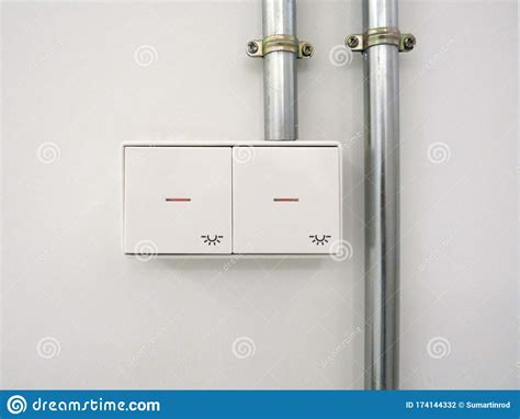 Light Switches On White Wall And Metal Tubes Industrial And Modern