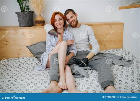 happy married couple chilling on a double bed at home stock image image of apartment