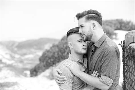 Gay Men Embracing On A Fence Stock Photo Download Image Now Adult