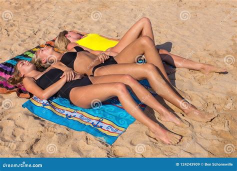 Three Blonde Dutch Girls Sunbathing On Beach Stock Image 124243909