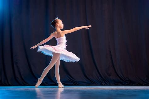 Bailarina De Niña Está Bailando En El Escenario En Tutú Blanco En