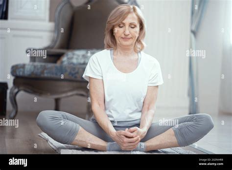 Woman Is Sitting With Crossed Legs Yoga Pose Stock Photo Alamy