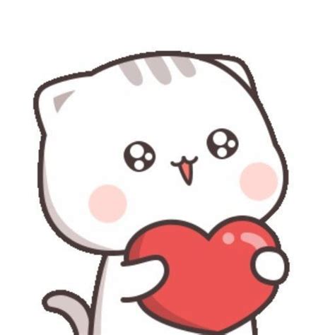 A White Cat Holding A Red Heart In Its Paws