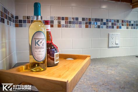 Our kitchen has dark stained maple here is how to install a classic white subway tile backsplash in your kitchen. White subway tile backsplash with mosaic multi-colored ...