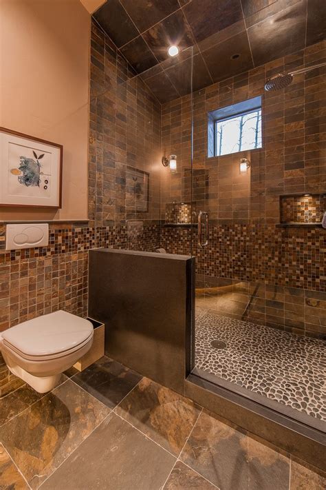 Use mosaic or tile drops. Pebble Bathroom Floor Rustic with Wood Tub Surround ...