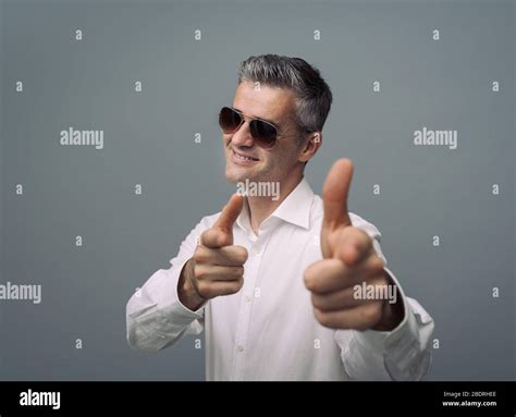 Cool Friendly Guy Pointing At Camera With A Finger Gun Gesture And