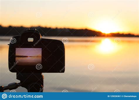 Photo Of Beautiful Riverside Sunset On Display Of Professional Camera