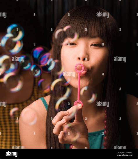 Asian Woman Blowing Bubbles Stock Photo Alamy