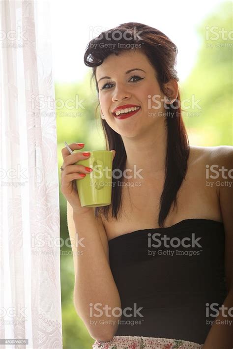 Beautiful Girl Drinking Tea Or Coffee Indoor Green Blurred Background