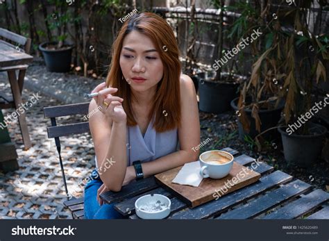sexy asian woman smoking cigarette cup ภาพสต็อก 1425620489 shutterstock