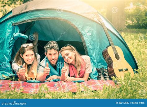 Group Of Best Friends With Thumbs Up In Camping Tent Stock Image