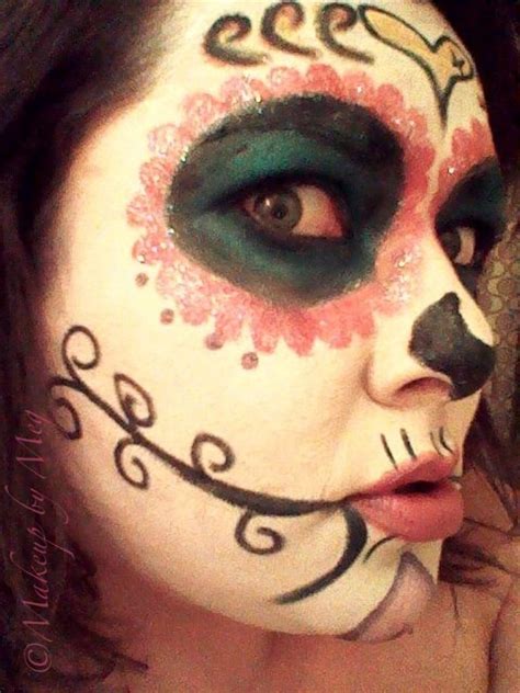 A Woman With Makeup Painted To Look Like A Cat And Skull Face Paint On