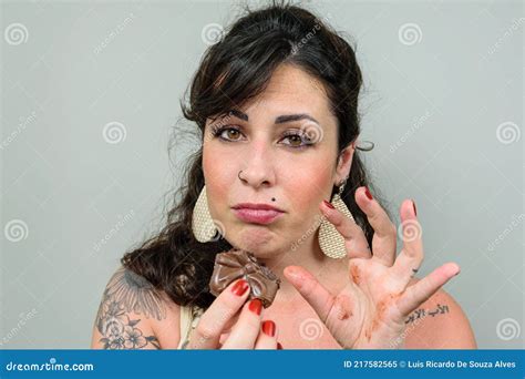 Tattooed Woman Looking For A Camera With A Sad Face For Having Eaten