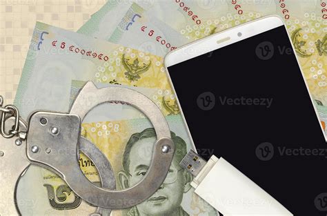 20 thai baht bills and smartphone with police handcuffs concept of hackers phishing attacks