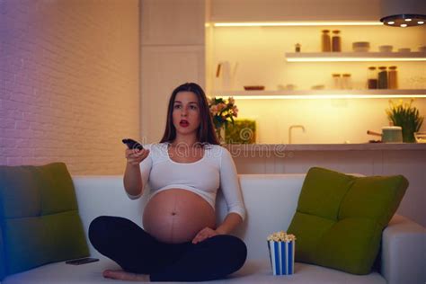 filme de excitação de observação da mulher gravida em casa apenas imagem de stock imagem de