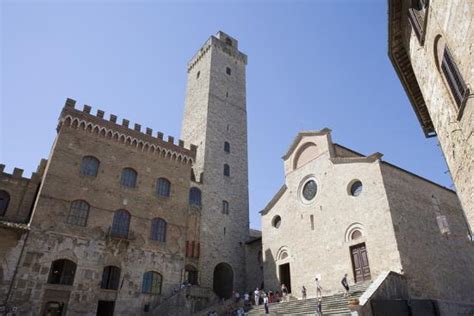 tower palazzo del popolo and faade of duomo in san gimignano tuscany italy photographic