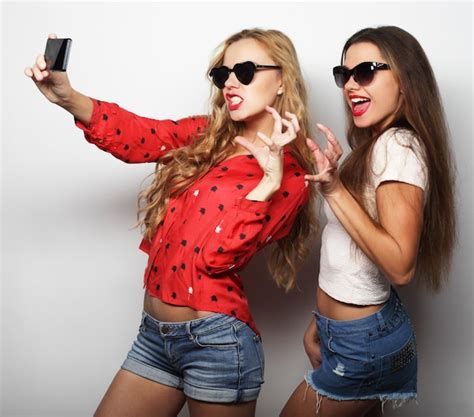 Premium Photo Two Teenage Girls Friends In Hipster Outfit Make Selfie