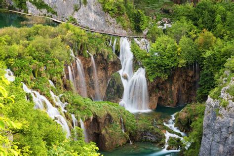 Beautiful View Of Waterfalls With Turquoise Water And Wooden Pathway