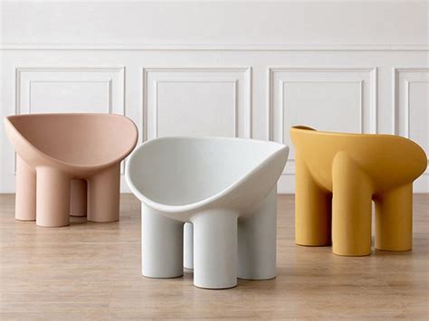Three Different Colored Stools Sitting On Top Of A Wooden Floor Next To