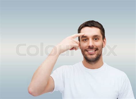 Smiling Young Handsome Man Pointing To Forehead Stock Image Colourbox