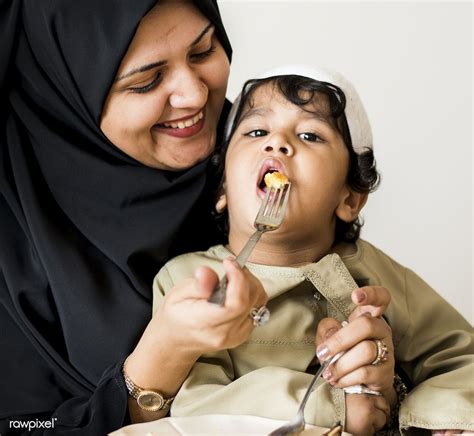 Download Premium Image Of Muslim Woman Feeding Her Son 425895 Muslim Women Women Mother Feeding