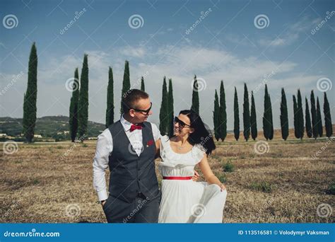 happy stylish smiling couple walking and kissing in tuscany ita stock image image of