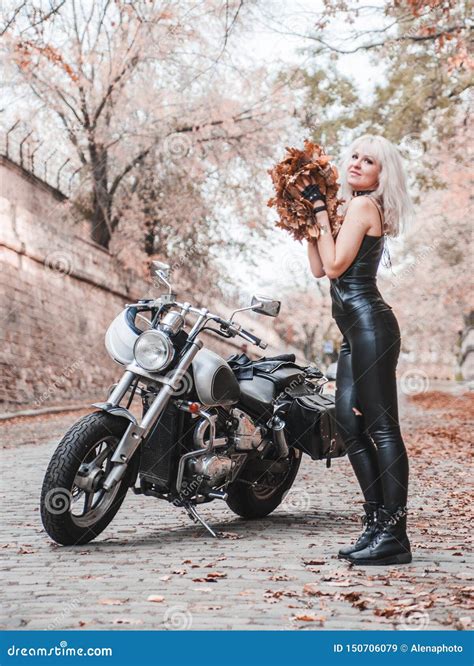 Beautiful Biker Woman Posing With Motorcycle Outdoors Stock Image