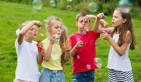 Children Blowing Bubbles In Park Stock Image Image Of Summer Park