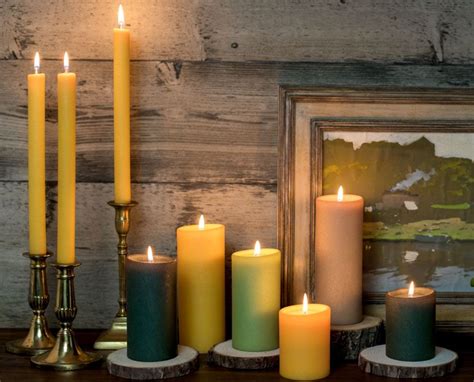 A Group Of Lit Candles Sitting On Top Of A Table Next To A Framed Photo