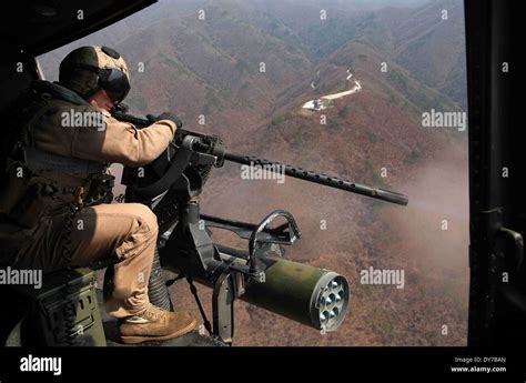 A Us Marine Fires The Door Gun On A Uh 1y Venom Helicopter While
